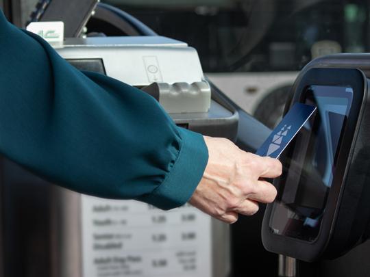 A person tapping their Clipper card