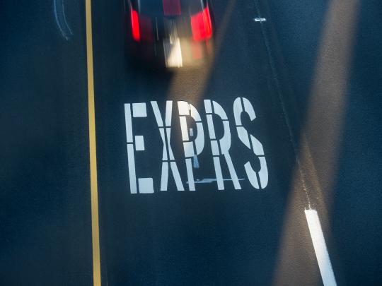 picture of a road with EXPRS on the lane car is passing it