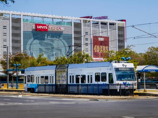 A picture of Levi's stadium with a VTA train in front