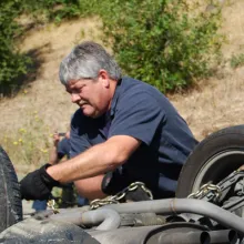 Technicians on the road inspecting a flip over vehicle