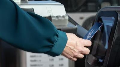 A person tapping their Clipper card.