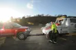 A towtruck operator hooks up a disabled red SUV to a towtruck with a 511 Freeway Assist logo on the door