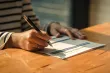 An application form being filled out in pen