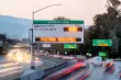 A freeway express lane sign displaying the toll to Alcosta Blvd, and indicating that Fastrak is required to pay the toll.