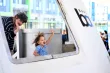 mom and child waving out of a train window
