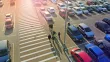 Aerial view of a large parking lot with commuters walking down a crosswalk in the middle