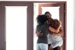 A family hugging in a doorway