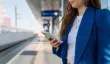Woman checking her phone while waiting for public transit