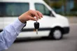 A hand holding car keys.