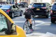 A woman riding a bike in traffic