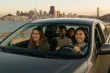 A happy group of friends carpooling with San Francisco in the background.  AI Generated image