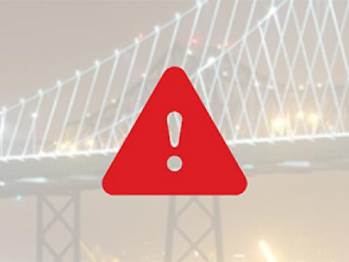 A red alert icon over a faded image of a bridge