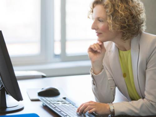 Woman looking at computer screen.